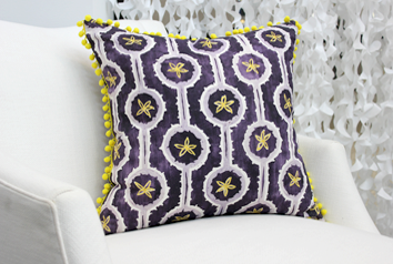 purple leap pillow on a white chair